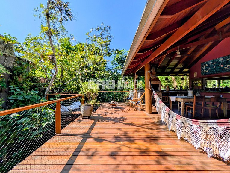 Casa de palafita, cercada por árvores