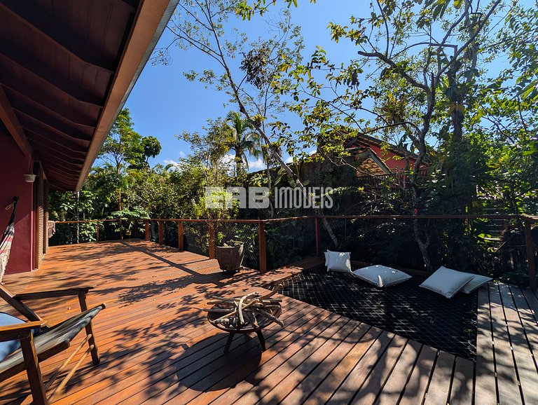 Casa de palafita, cercada por árvores