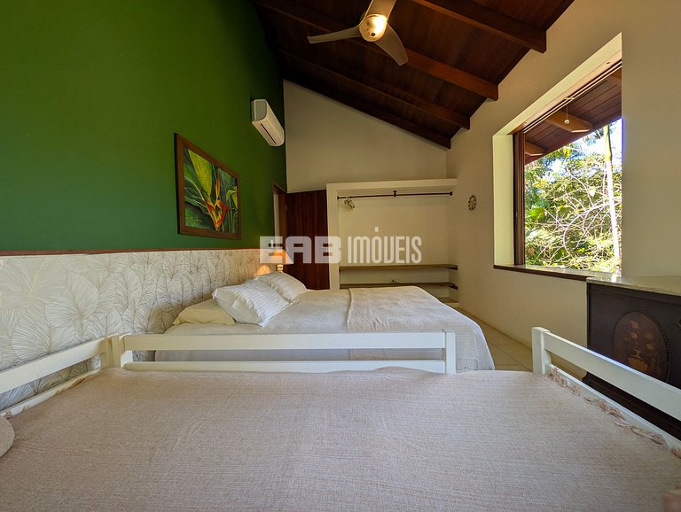 Casa de palafita, cercada por árvores